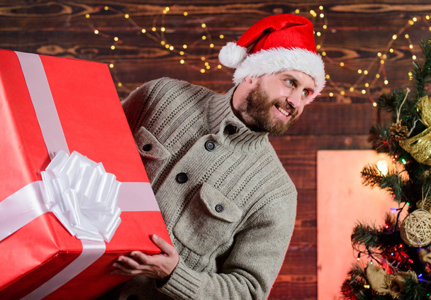Spread happiness. Giving happiness. Winter happiness. Happy holidays. Santa Claus. Smiling guy with giant gift box. I am here to give present. Delivering happiness to your home. Delivery service - Foto, afbeelding