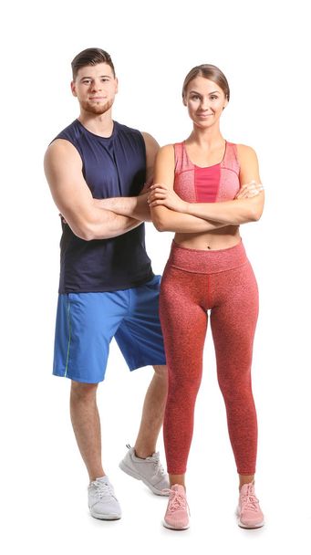 Sporty young couple on white background - Фото, зображення
