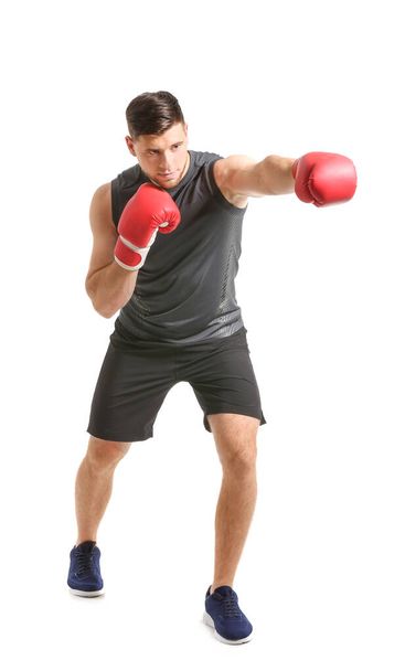 Sporty young boxer on white background - Фото, зображення