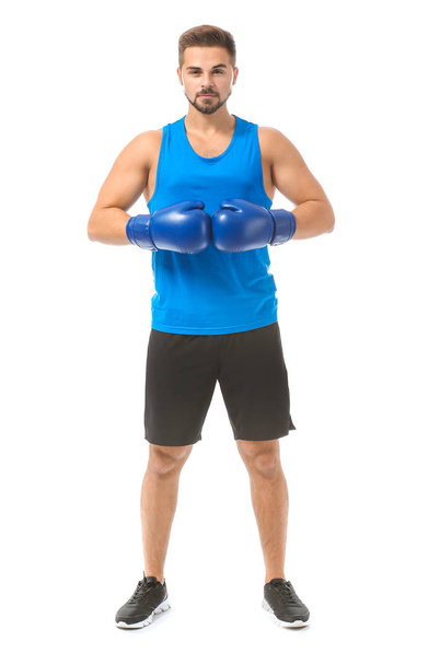Sporty young boxer against white background - Zdjęcie, obraz