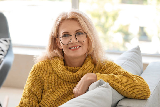 Portrait of beautiful mature woman at home - Photo, Image