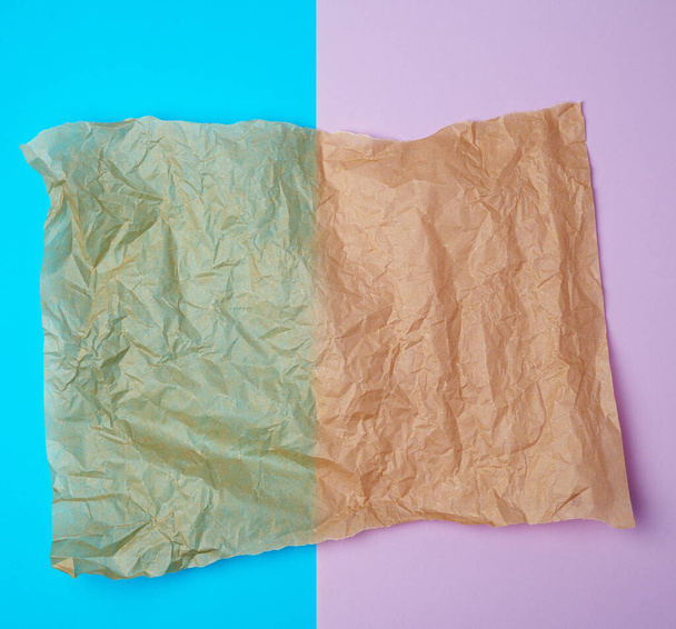 https://cdn.create.vista.com/api/media/small/323909578/stock-photo-torn-brown-pieces-of-parchment-paper-on-a-blue-purple-background