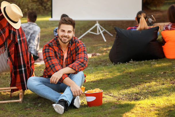 Young man in outdoor cinema - Foto, imagen