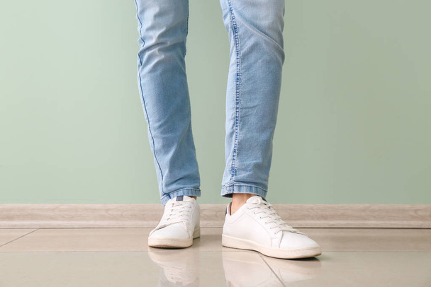 Young man in stylish shoes near color wall - Fotoğraf, Görsel