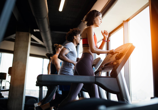 Healthy young athletes people doing exercises at gym. - Valokuva, kuva
