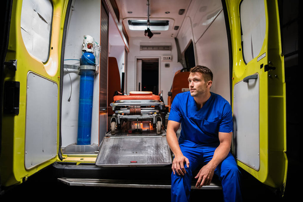Il medico si siede sulla macchina dell'ambulanza e pensa:
 - Foto, immagini