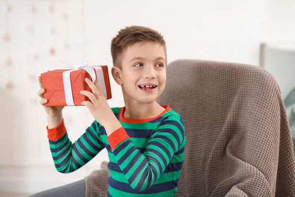 Cute little boy with Christmas gift at home - Foto, Bild