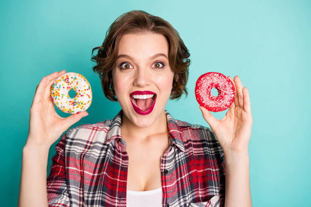 Close up photo of crazy funky girl hold two donuts unbelievable yummy unhealthy food scream wow omg wear stylish clothing isolated over teal color background - Photo, Image