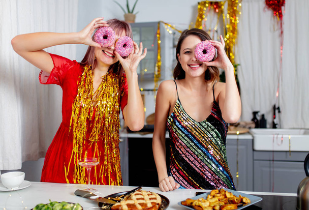 dwie dziewczyny dobrze się bawią w kuchni po imprezie, koncepcja świąteczna - Zdjęcie, obraz