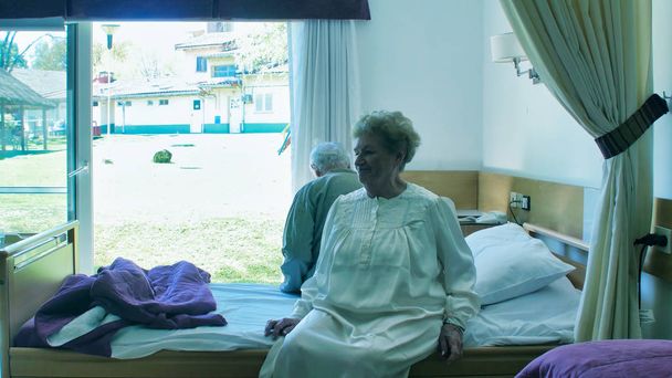 Elderly retired caucasian couple waking up from the bed in the morning. Retirement concept. - Photo, Image