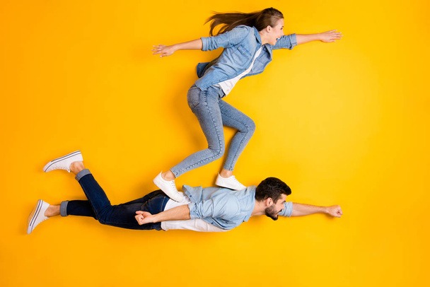 Top view above high angle flat lay flatlay lie full length body size view concept of his he her she beautiful handsome spouse flying isolated on bright vivid shine vibrant yellow color background - Photo, Image