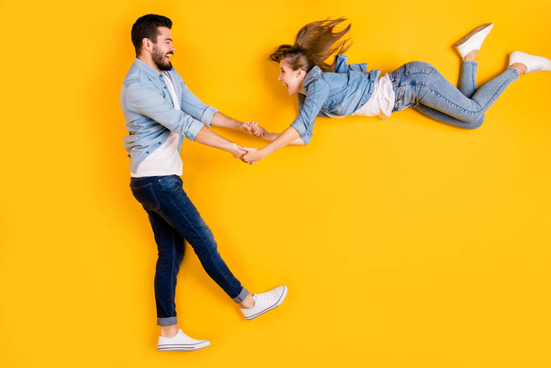 Top view above high angle flat lay flatlay lie full length body size view concept of cheerful cheery beautiful handsome spouse having fun isolated on bright vivid shine vibrant yellow color background - Foto, immagini