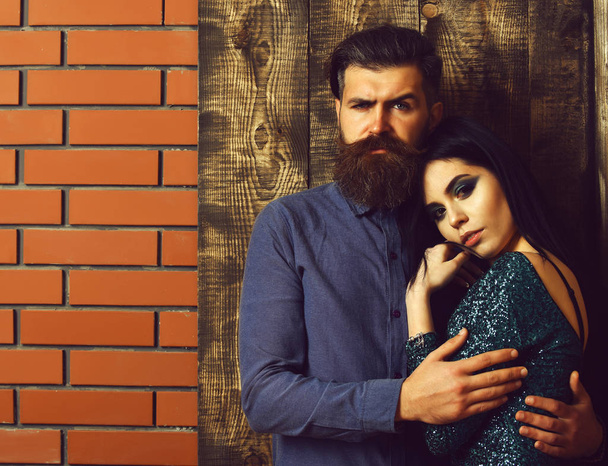 bearded man and pretty sexy woman on brick wood background - Fotó, kép