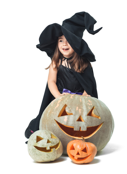 little witch hiding behind pumpkins - Foto, Bild