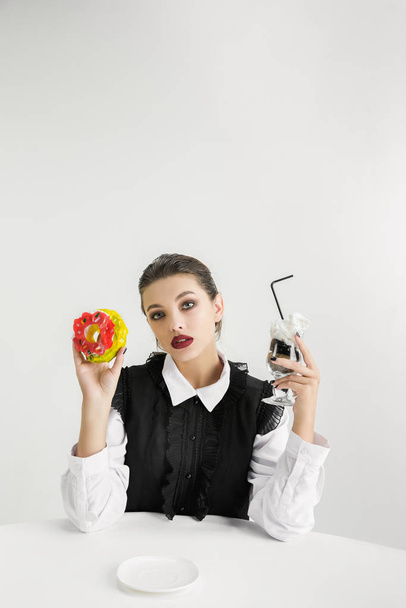 We are what we eat. Womans eating plastic food, eco concept - Фото, изображение