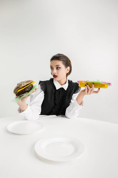 We are what we eat. Womans eating plastic food, eco concept - Photo, Image