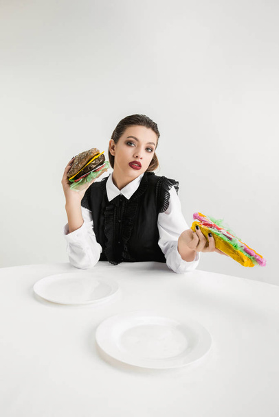 We are what we eat. Womans eating plastic food, eco concept - Фото, зображення