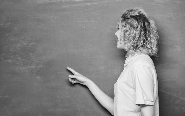 woman teacher at school lesson. back to school. woman likes studying. knowledge day. empty blackboard information. student pointing at blackboard. university or college. copy space. Modern school - Photo, Image