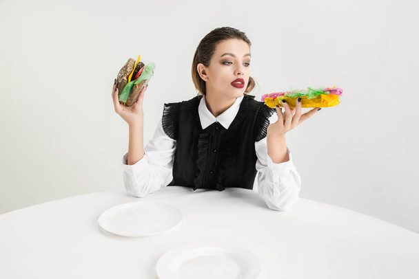 We are what we eat. Womans eating plastic food, eco concept - Foto, imagen