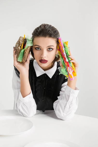 We are what we eat. Womans eating plastic food, eco concept - Foto, Imagem