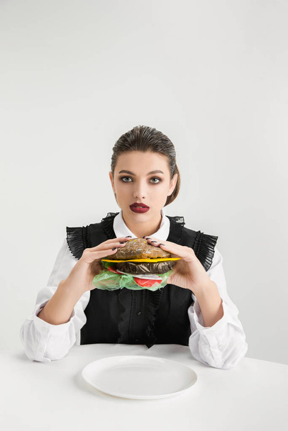 We are what we eat. Womans eating plastic food, eco concept - Fotografie, Obrázek