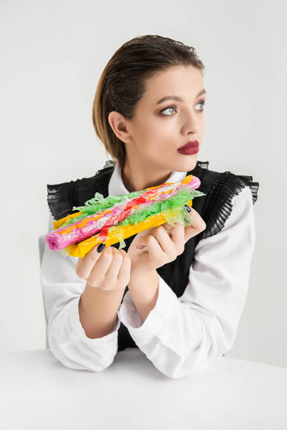 We are what we eat. Womans eating plastic food, eco concept - 写真・画像