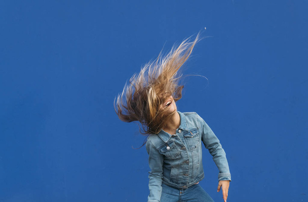 Little girl with blonde hair spinning outside - Valokuva, kuva