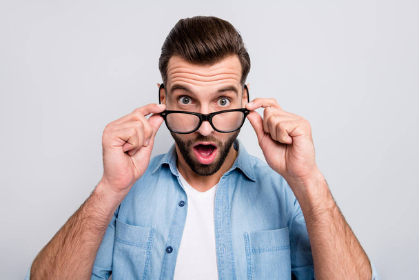 Closeup photo of crazy business guy open mouth taking off glasses not believe eyes awful situation epic fail wear specs casual denim outfit isolated grey color background - Fotografie, Obrázek