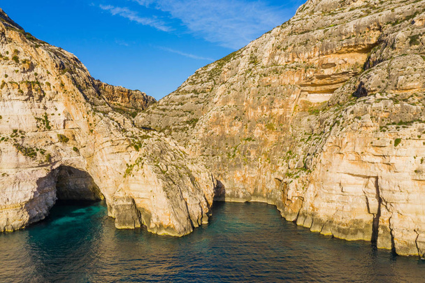 Aerial view of caves, cliffs and boat. Blue clear sky, rocks. Malta country - Photo, Image