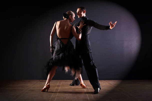 Dancers in ballroom isolated on black background - Fotó, kép