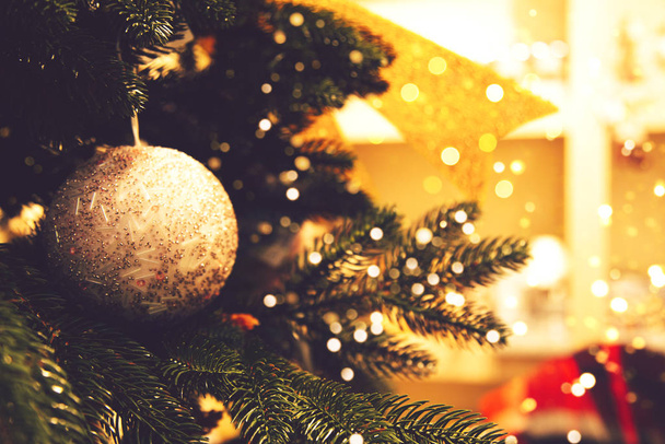 Shiny Christmas ball hanging on pine branches - Fotoğraf, Görsel