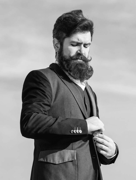 Flawless outfit. Businessman bearded face sky background. Man formal suit adjusting jacket. Male fashion formal menswear. Fashion trend. Guy beard and mustache wear formal clothes. Just right - Valokuva, kuva