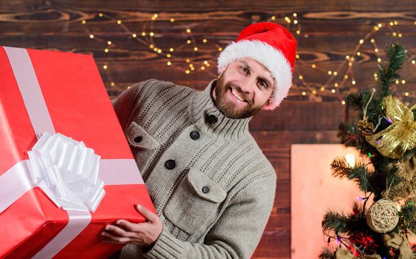 Delivering happiness to your home. Delivery service. Spread happiness. Giving happiness. Winter happiness. Happy holidays. Santa Claus. Smiling guy with giant gift box. I am here to give present - Photo, image
