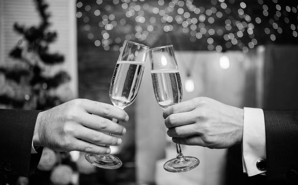 Cheers concept. New year corporate party. Party with champagne. Lets celebrate. Successful year. Drink champagne at party. Colleagues celebrate new year. Male hands formal suit hold champagne glasses - Foto, immagini