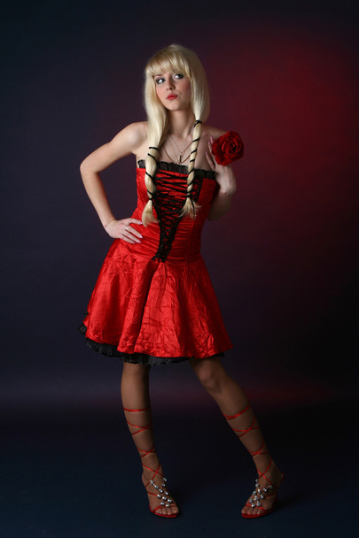 Sexy women in a red satiny dress - Фото, зображення