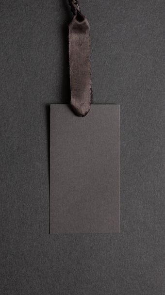 Black recycled price card against black background - Valokuva, kuva