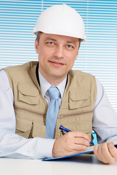 Fine man working in the construction helmet - Φωτογραφία, εικόνα