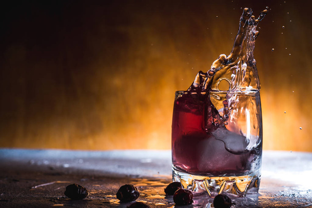  świeży koktajl jagodowy z lodem w szklanym tle napój w zamrożeniu ruchu, krople w płynie - Zdjęcie, obraz