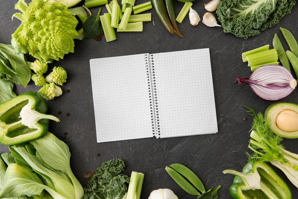 green vegetables and diary with empty pages - 写真・画像
