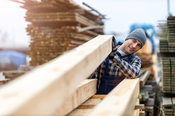 Young male worker in timber warehouse  - Fotoğraf, Görsel