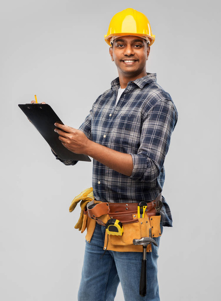 thinking builder with clipboard and pencil - Фото, зображення