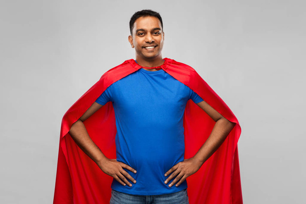 happy smiling indian man in red superhero cape - Foto, afbeelding
