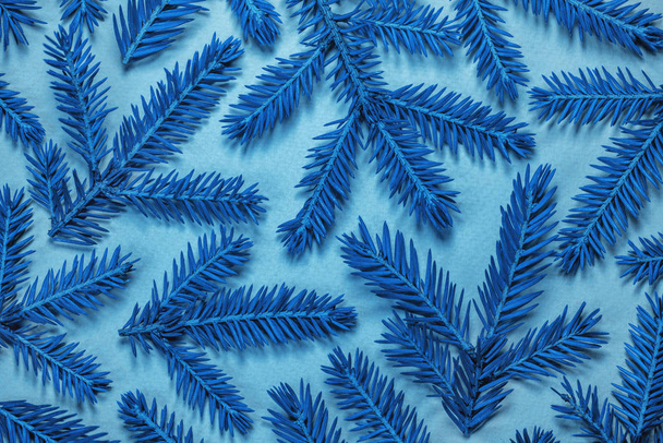 Classic blue color of the year 2020. Christmas composition. BLue branches on a light backdrop. Pattern of magical festive fir branches on a azure background. Flat lay, top view. - Фото, изображение