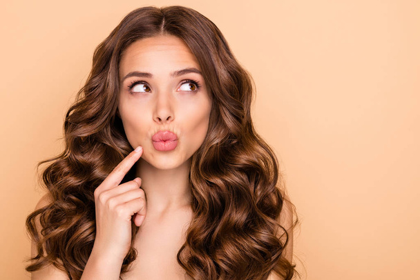 Close-up portrait of her she nice-looking attractive lovely gorgeous well-groomed pensive wavy-haired girl thinking looking aside pouted lips isolated over beige pastel color background - Fotó, kép