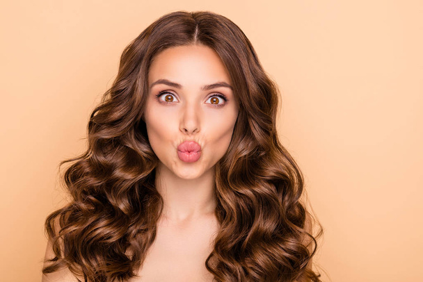 Close-up portrait of her she nice-looking attractive lovely gorgeous cheerful funny well-groomed wavy-haired girl sending air kiss perfect lips line isolated over beige pastel color background - Photo, Image