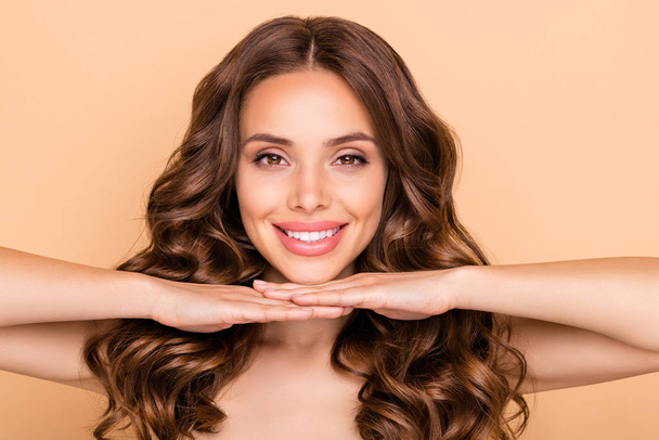 Close-up portrait of her she nice-looking attractive well-groomed cheerful cheery wavy-haired girl showing teeth whitening healthcare isolated over beige pastel color background - Foto, imagen
