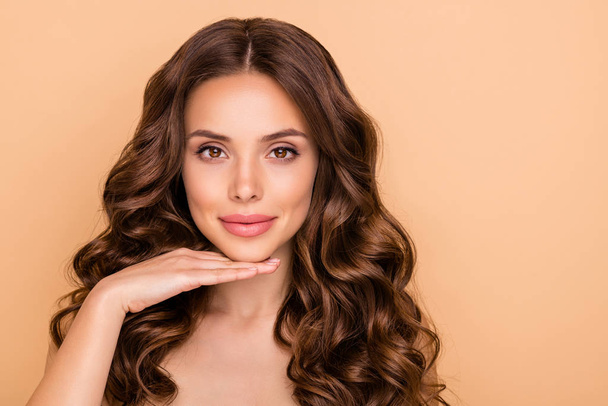 Close-up portrait of her she nice-looking attractive lovely sweet tender peaceful wavy-haired girl touching chin showing facelift effect isolated over beige pastel color background - Fotoğraf, Görsel
