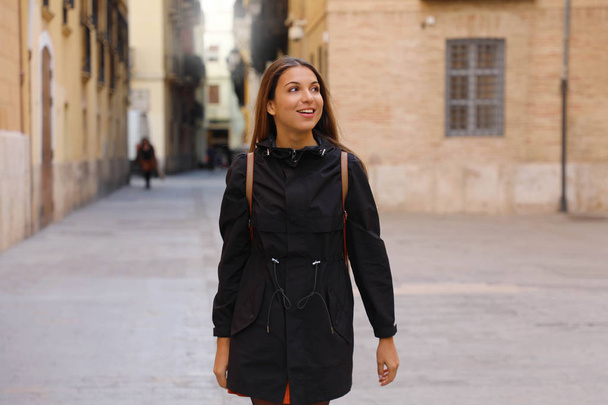 Curious girl travelling and visiting Europe in winter time. Backpacker girl walking in Valencia admiring spanish architecture. - Fotoğraf, Görsel