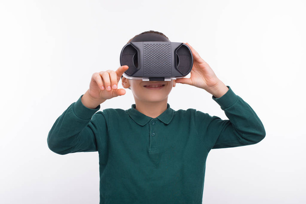 Portrait of happy young boy using VR glasses  - Photo, Image