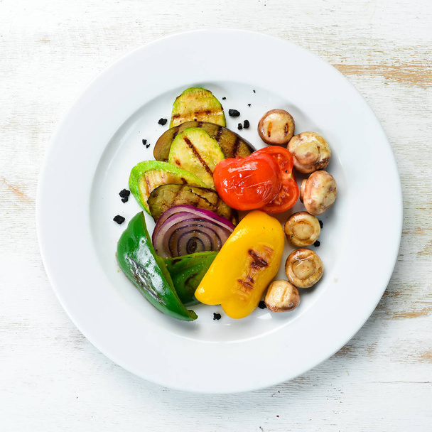 Grilled vegetables: zucchini, tomatoes, paprika, onion. Top view. Free space for your text. - Foto, afbeelding